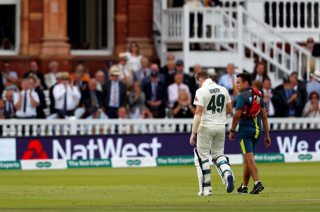 Smith leaves the pitch after being hit in the neck by Jofra Archer.
