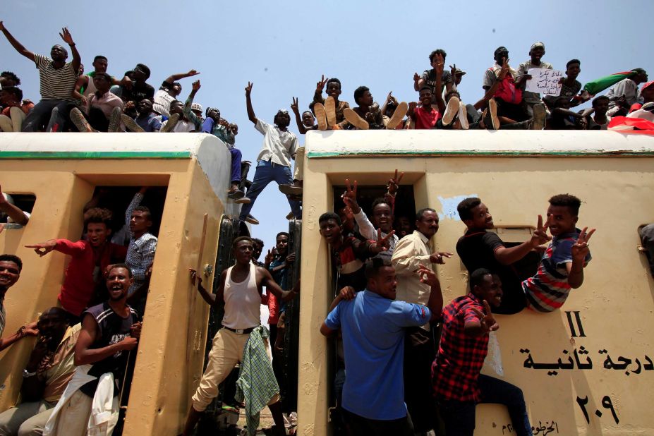 Sudanese civilians atop a train join in celebrations over the signing of a deal that paves the way for a transitional government in Khartoum, Sudan, on Saturday, August 17.