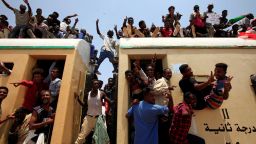 Sudanese civilians atop a train join in celebrations over the signing of a deal that paves the way for a transitional government in Khartoum, Sudan, on Saturday, August 17.