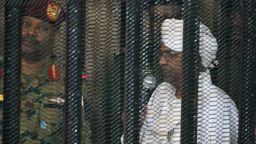 Sudan's deposed military ruler Omar al-Bashir stands in a defendant's cage during the opening of his corruption trial in Khartoum on August 19, 2019. - Bashir has admitted to receiving $90 million in cash from Saudi monarchs, an investigator told a Khartoum court today. (Photo by Ebrahim HAMID / AFP)        (Photo credit should read EBRAHIM HAMID/AFP/Getty Images)