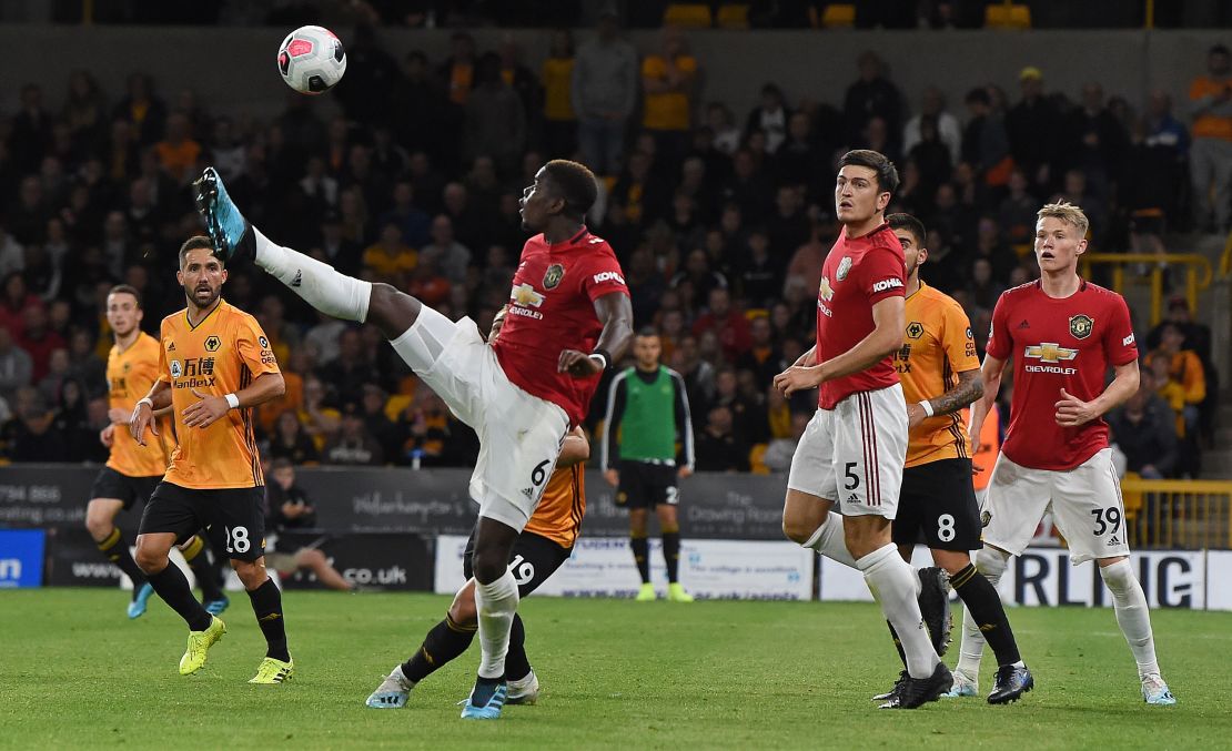 Paul Pogba (C) attempts to control the ball during the English Premier League football match between Wolverhampton Wanderers and Manchester United.