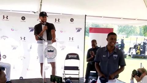 Steph Curry, left, and student Otis Ferguson, right, smile at the announcement of the Howard University golf program.