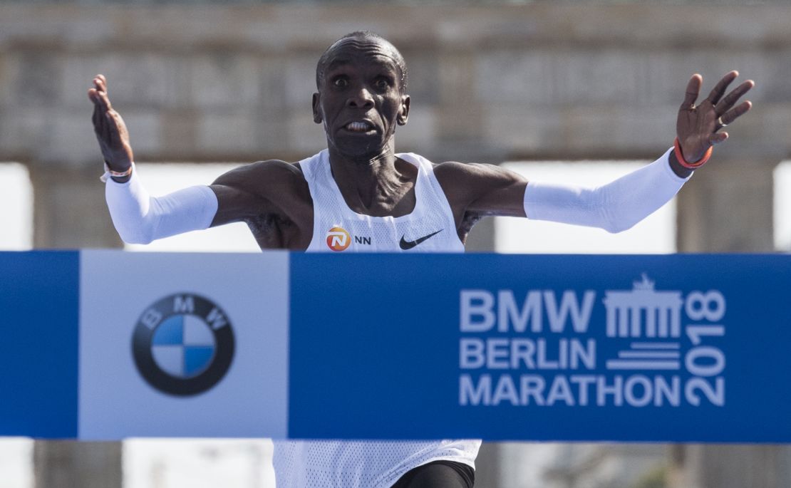 Kipchoge crosses the finish line to win the Berlin Marathon, setting a new world record.