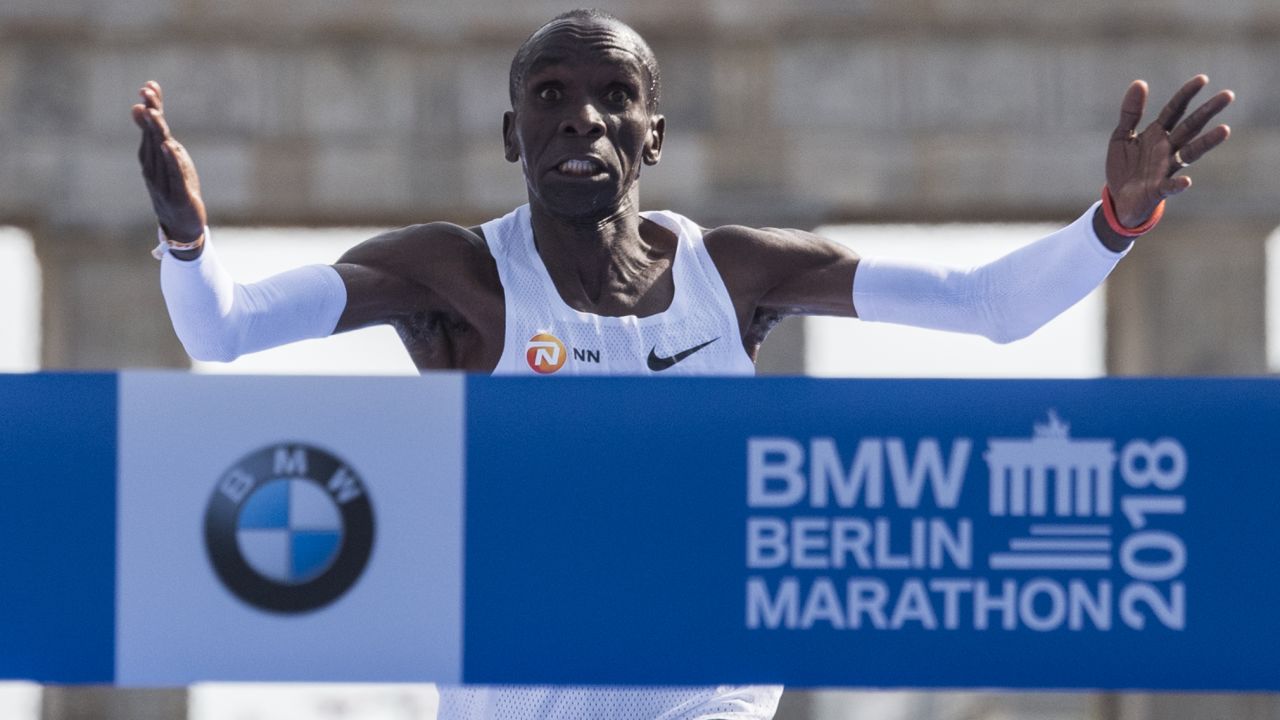 Kipchoge crosses the finish line to win the Berlin Marathon, setting a new world record.
