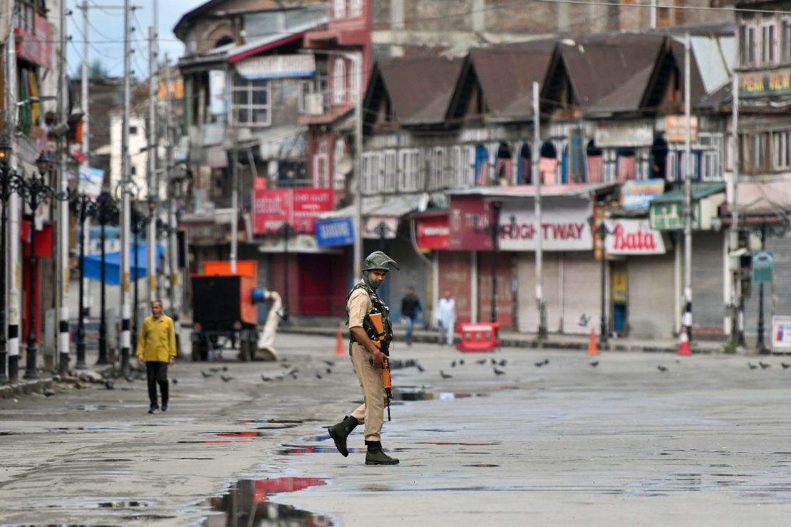 A security personnel patrols on a deserted road of the Lal Chowk area in Srinagar on August 19, 2019.