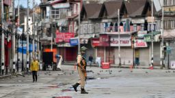 A security personnel patrols on a deserted road of the Lal Chowk area in Srinagar on August 19, 2019. - Some Kashmir schools re-opened on August 19 but many pupils stayed away, following weekend clashes after India stripped the region of its autonomy and imposed a lockdown two weeks ago. (Photo by PUNIT PARANJPE / AFP)        (Photo credit should read PUNIT PARANJPE/AFP/Getty Images)