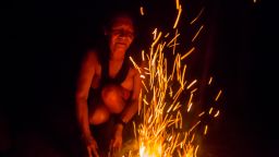 Chief Ajareaty Waiapi builds a bonfire outside her home in Kwapo'ywyry village. She's been working on finding ways to communicate with non-indigenous Brazilians, including studying Portuguese in a local school. The Waiapi fear great fires and floods may destroy the planet if they don't fight to protect the rainforest.