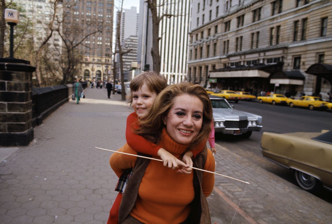 Walters carries her daughter, Jackie, circa 1970. Jackie is Walters' only child. She adopted her with her second husband, Lee Guber.