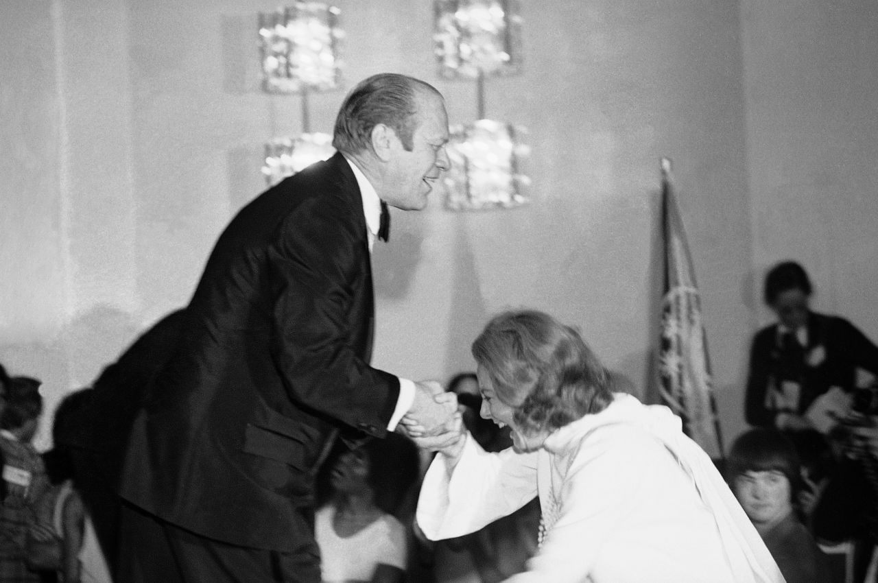 President Gerald Ford gives Walters a helping hand after she slipped during a White House awards presentation in 1975.