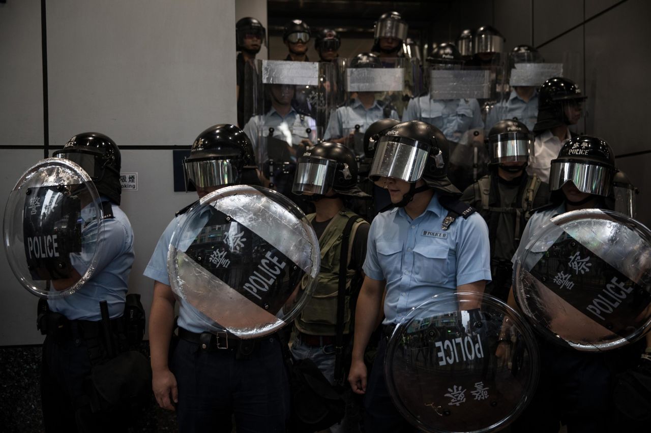 Police stand guard outside Mong Kok police station as pro-democracy protesters gather on August 17, 2019 in Hong Kong.