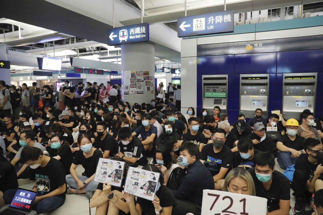 Pro-democracy protesters demonstrate at the Yuen Long MTR station, marking one month since suspected triad gang attacked members of the movement.