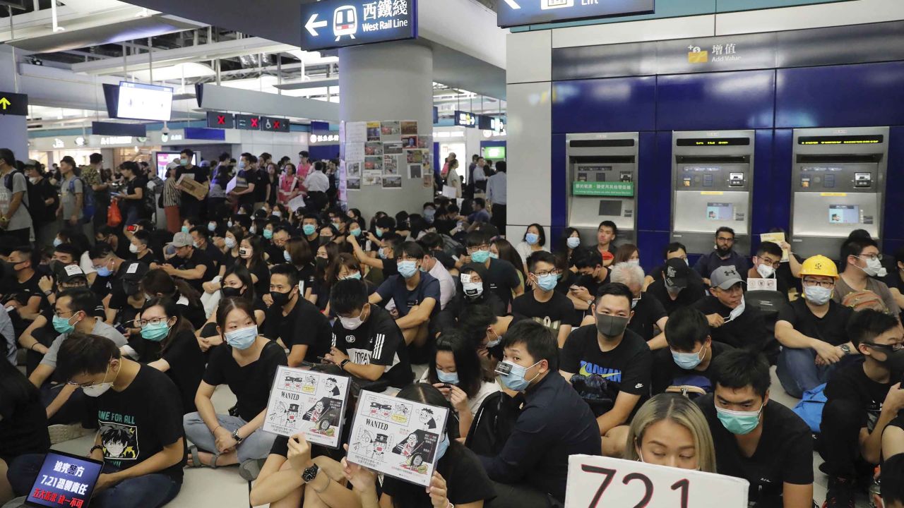 Pro-democracy protesters demonstrate at the Yuen Long MTR station, marking one month since suspected triad gang attacked members of the movement.