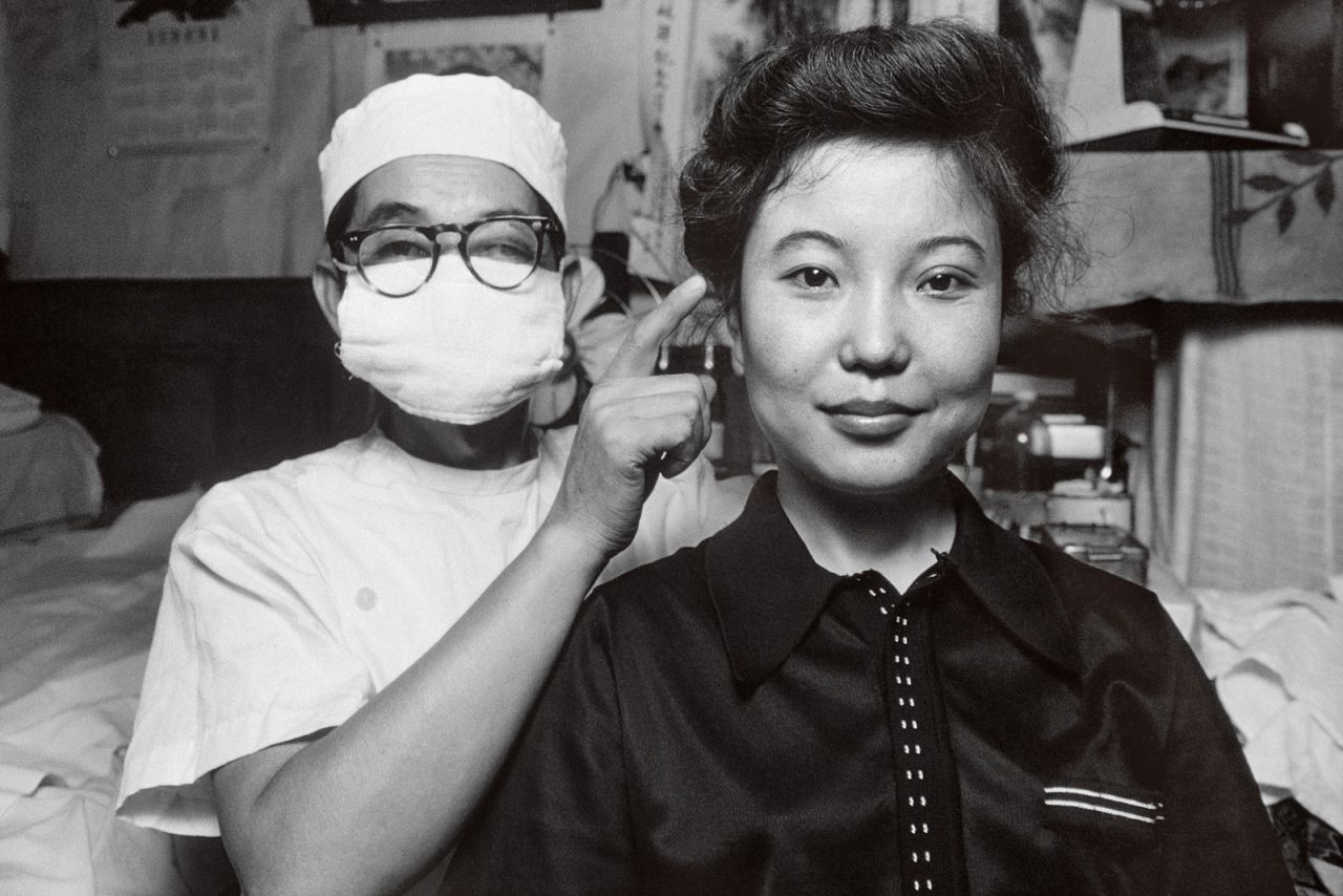 A doctor with a patient in Beijing who underwent plastic surgery for so-called "double eyelids."