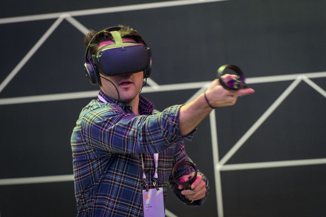 An attendee uses the Oculus VR Inc. Quest virtual reality (VR) headset and controllers during the F8 Developers Conference in San Jose, California, U.S., on Tuesday, April 30, 2019. Facebook Inc.s Oculus virtual-reality division will start shipping its new Quest and Rift S headsets on May 21. Photographer: David Paul Morris/Bloomberg via Getty Images