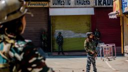 SRINAGAR, KASHMIR, INDIA - AUGUST 20: Indian paramilitary troopers stand guard in front the shuttered shops in the deserted city center, on August 20, 2019 in Srinagar, the summer capital of Indian administered Kashmir, India.  Curfew like restrictions remain in place in Kashmir for the fourteenth consecutive day after India revoked articles 370 and 35A, and phone and internet services also remained suspended. Article 35A of the Indian Constitution was an article that empowered the Jammu and Kashmir state's legislature to define permanent residents of the state and provided special rights and privileges to those permanent residents, also preventing non-locals from buying or owning property in the state. Prior to 1947, Jammu and Kashmir was a princely state under the British Empire. It was added to the Constitution through a Presidential Order. The Constitution Order 1954, (Application to Jammu and Kashmir) was issued by the President of India on 14 May, 1954 in accordance with Article 370 of the Indian Constitution, and with the concurrence of the Government of the State of Jammu and Kashmir. Kashmir has been a state under siege, with both India and Pakistan laying claim to it. Human rights organizations say more than 80,000 have died in the two decade long conflict with the Indian government claiming the number as 42,000. (Photo by Yawar Nazir/ Getty Images)