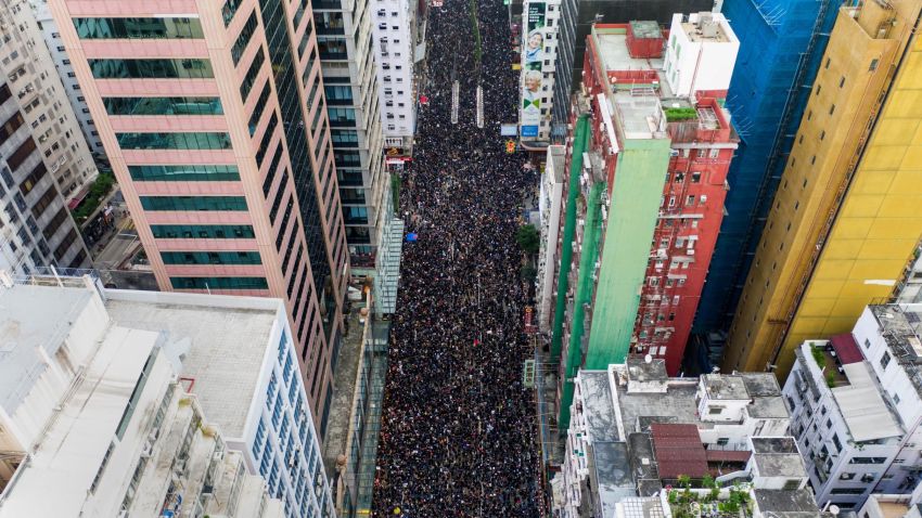 TOPSHOT - This overhead view shows thousands of protesters marching through the street as they take part in a new rally against a controversial extradition law proposal in Hong Kong on June 16, 2019. - Tens of thousands of people rallied in central Hong Kong on June 16 as public anger seethed following unprecedented clashes between protesters and police over an extradition law, despite a climbdown by the city's embattled leader. (Photo by STR / AFP)        (Photo credit should read STR/AFP/Getty Images)