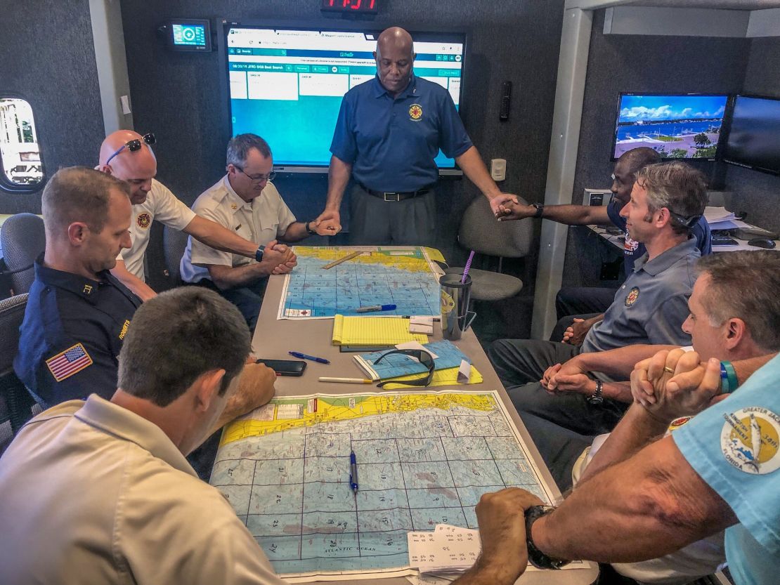 Rescue officials strategize the search for the two missing firefighters.