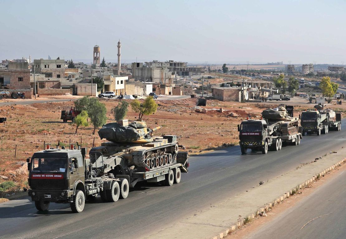 A convoy of Turkish military vehicles passes through the town of Saraqeb in Idlib province on August 19, 2019.
