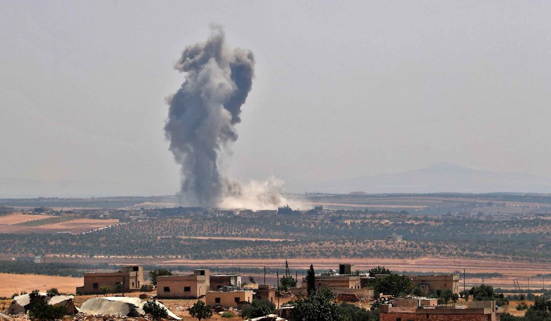 Smoke billows above buildings during a reported air strike by pro-regime forces on Khan Sheikhoun on August 19, 2019.