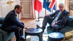 TOPSHOT - Britain's Prime Minister Boris Johnson (R) places his foot on the table during a meeting with French President Emmanuel Macron (L) at the Elysee Palace in Paris, France, on August 22, 2019. - British Prime Minister is visiting Paris, a day after Berlin offered a glimmer of hope that an agreement could be reached to avoid a chaotic "no deal" Brexit. On the second leg of his first foreign visit since taking office, he will meet the French President at the Elysee palace to press home his message that elements of the UK's impending divorce from the European Union must be renegotiated. (Photo by Christophe PETIT TESSON / POOL / AFP)        (Photo credit should read CHRISTOPHE PETIT TESSON/AFP/Getty Images)