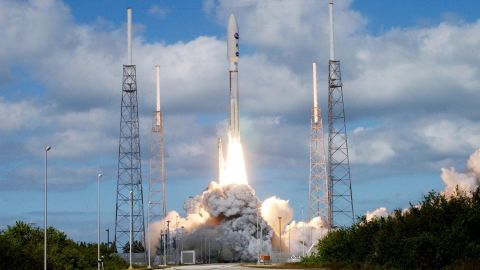 KENNEDY SPACE CENTER, FLA. — Into a cloud-scattered blue sky, NASA's New Horizons spacecraft roars off the launch pad aboard an Atlas V rocket spewing flames and smoke. Liftoff was on time at 2 p.m. EST from Complex 41 on Cape Canaveral Air Force Station in Florida. This was the third launch attempt in as many days after scrubs due to weather concerns. The compact, 1,050-pound piano-sized probe will get a boost from a kick-stage solid propellant motor for its journey to Pluto. New Horizons will be the fastest spacecraft ever launched, reaching lunar orbit distance in just nine hours and passing Jupiter 13 months later. The New Horizons science payload, developed under direction of Southwest Research Institute, includes imaging infrared and ultraviolet spectrometers, a multi-color camera, a long-range telescopic camera, two particle spectrometers, a space-dust detector and a radio science experiment. The dust counter was designed and built by students at the University of Colorado, Boulder. The launch at this time allows New Horizons to fly past Jupiter in early 2007 and use the planet's gravity as a slingshot toward Pluto. The Jupiter flyby trims the trip to Pluto by as many as five years and provides opportunities to test the spacecraft's instruments and flyby capabilities on the Jupiter system. New Horizons could reach the Pluto system as early as mid-2015, conducting a five-month-long study possible only from the close-up vantage of a spacecraft.