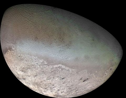 Neptune's largest moon, Triton, surprised scientists with its active surface. Methane ice, shown with a pink tone, may comprise a massive polar cap on the moon's surface. The dark swaths over the ice are likely dust that land from plumes erupting on the surface. 