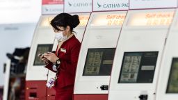 A Cathay Pacific employee walks past a row of self check-in counters at the international airport in Hong Kong on March 15, 2017. 
Hong Kong's troubled flagship airline Cathay Pacific swung to a 74 million USD loss in 2016, the firm said March 15, citing "intense competition" from rival carriers.
 / AFP PHOTO / Anthony WALLACE        (Photo credit should read ANTHONY WALLACE/AFP/Getty Images)