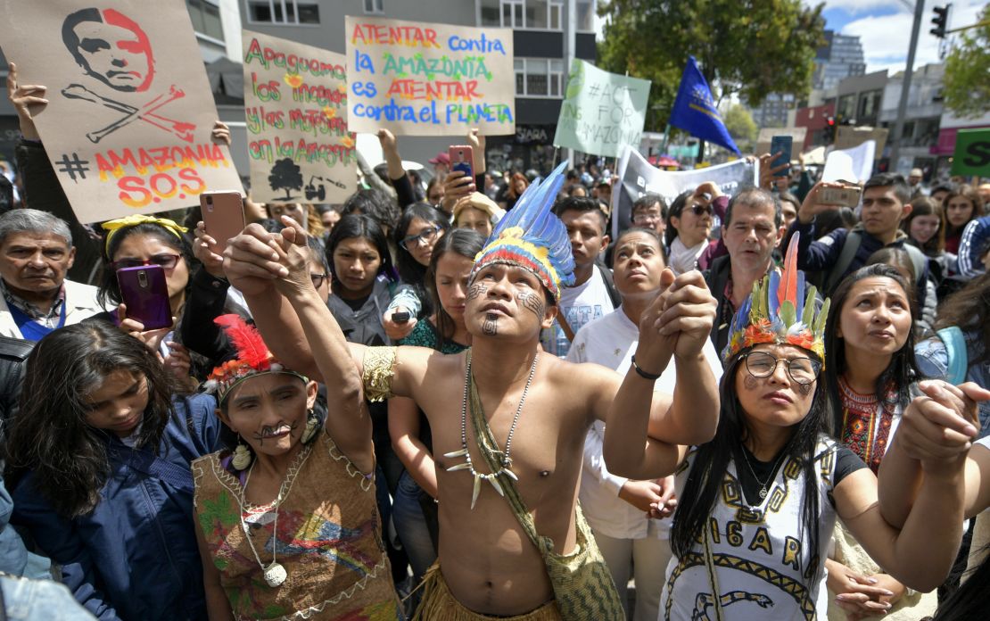 Colombian natives and activists protest against the government of Brazilian President Jair Bolsonaro over the fires in the Amazon rainforest.