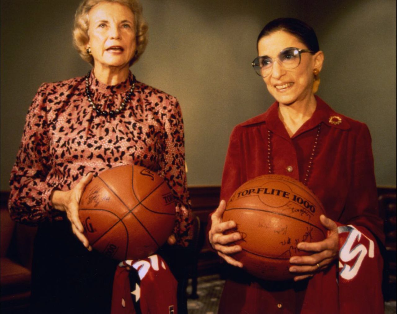 Ginsburg and fellow Justice Sandra Day O'Connor hold basketballs given to them by the US women's basketball team in December 1995.