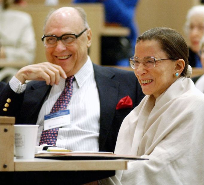 Ginsburg and her husband laugh as they listen to Supreme Court Justice Stephen Breyer speak at Columbia Law School in September 2003.