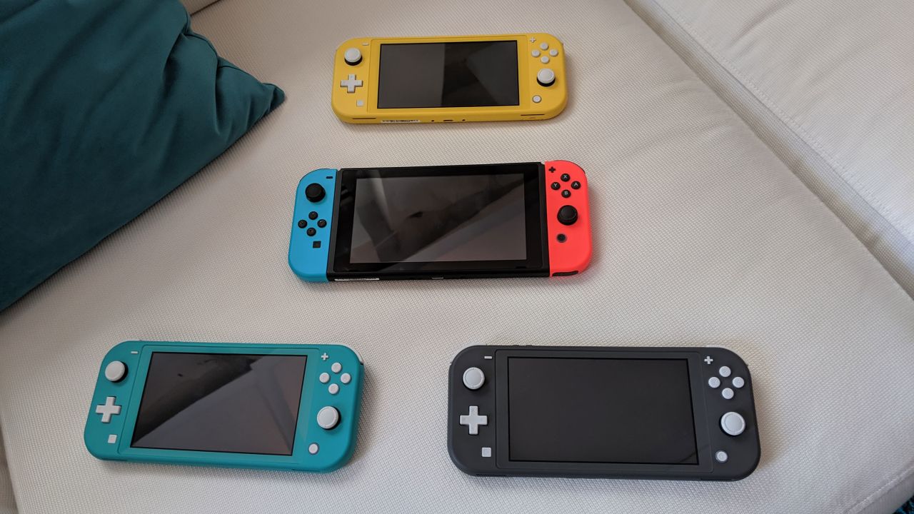 The original Nintendo Switch with blue and red Joy-Cons is accompanied by the Switch Lite in yellow, turquoise and gray.