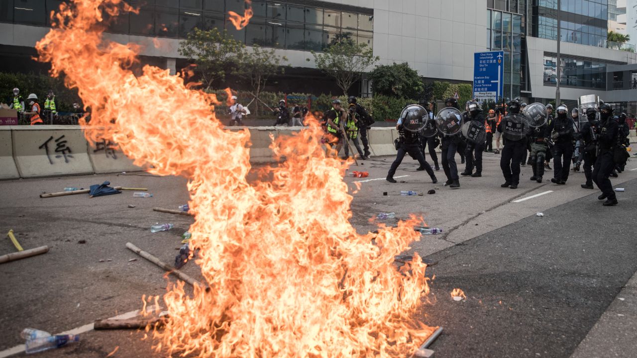 Police retreat after clashing with protesters after a rally in Kwun Tong in Hong Kong on Saturday.