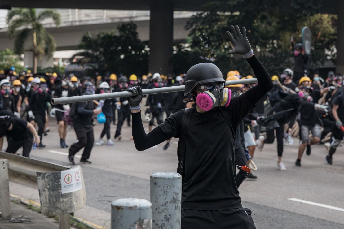 A protester prepares to throw a metal pole during clashes after a rally in Kwun Tong on Saturday.