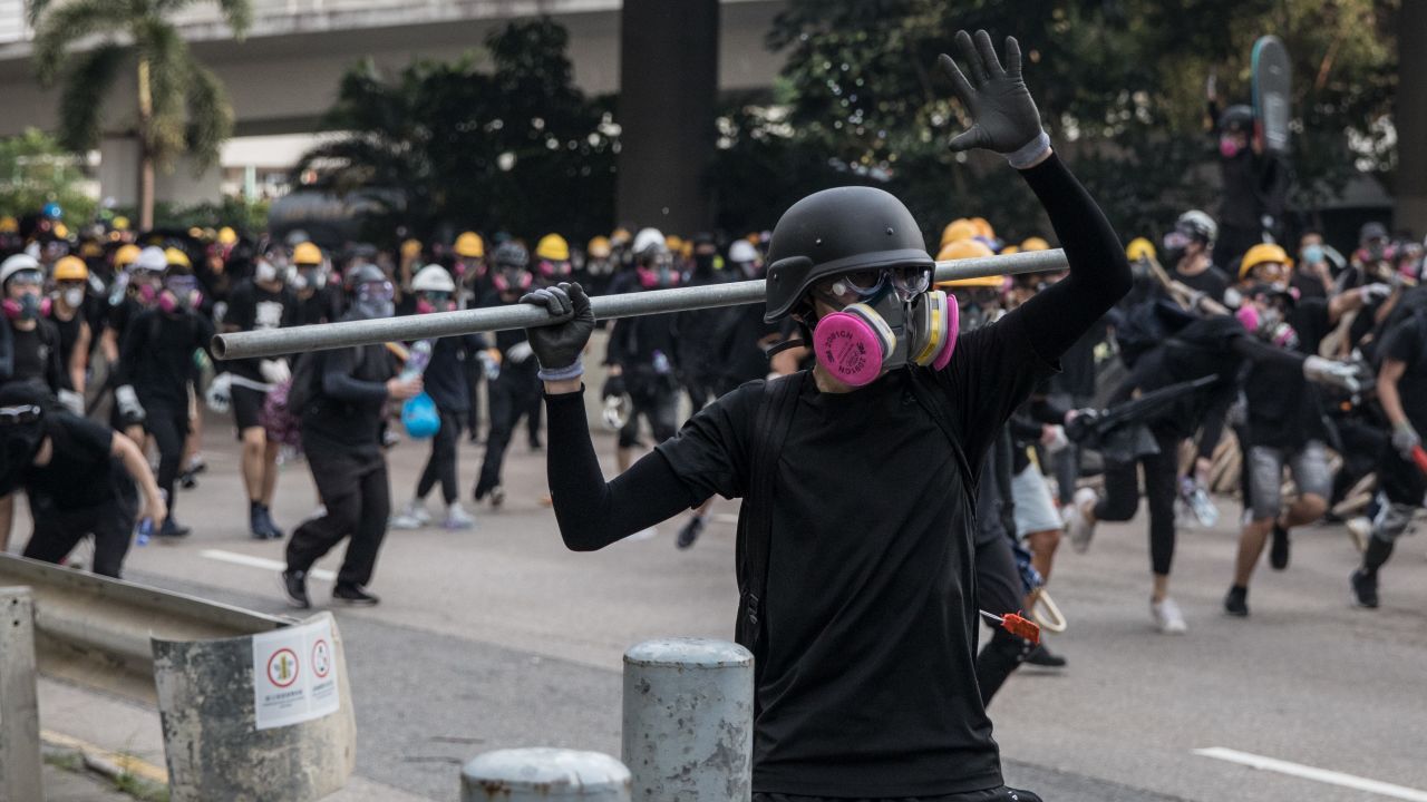 A protester prepares to throw a metal pole during clashes after a rally in Kwun Tong on Saturday.