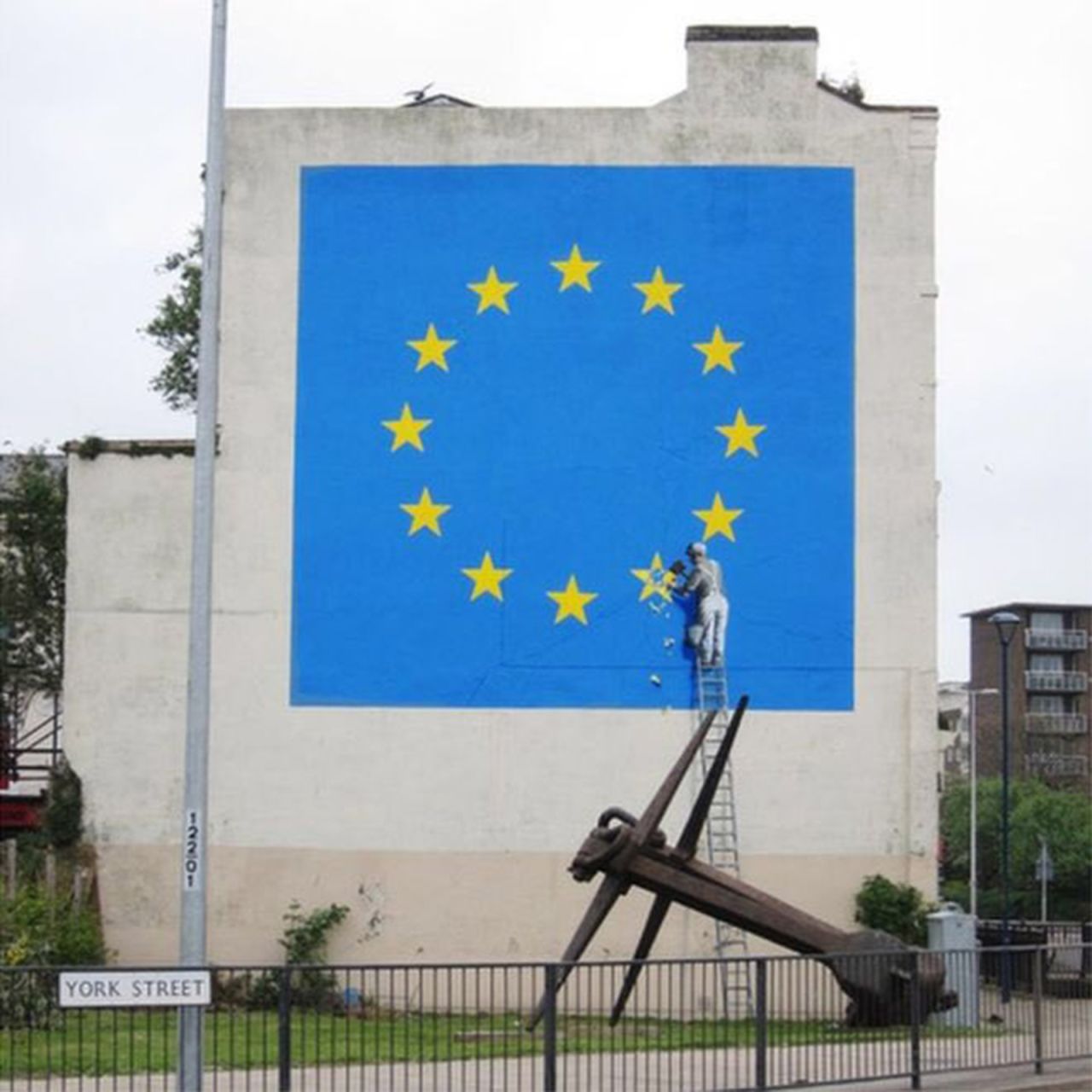 Banksy's Brexit mural depicted a workman chipping away at one of the stars in the European Union flag.