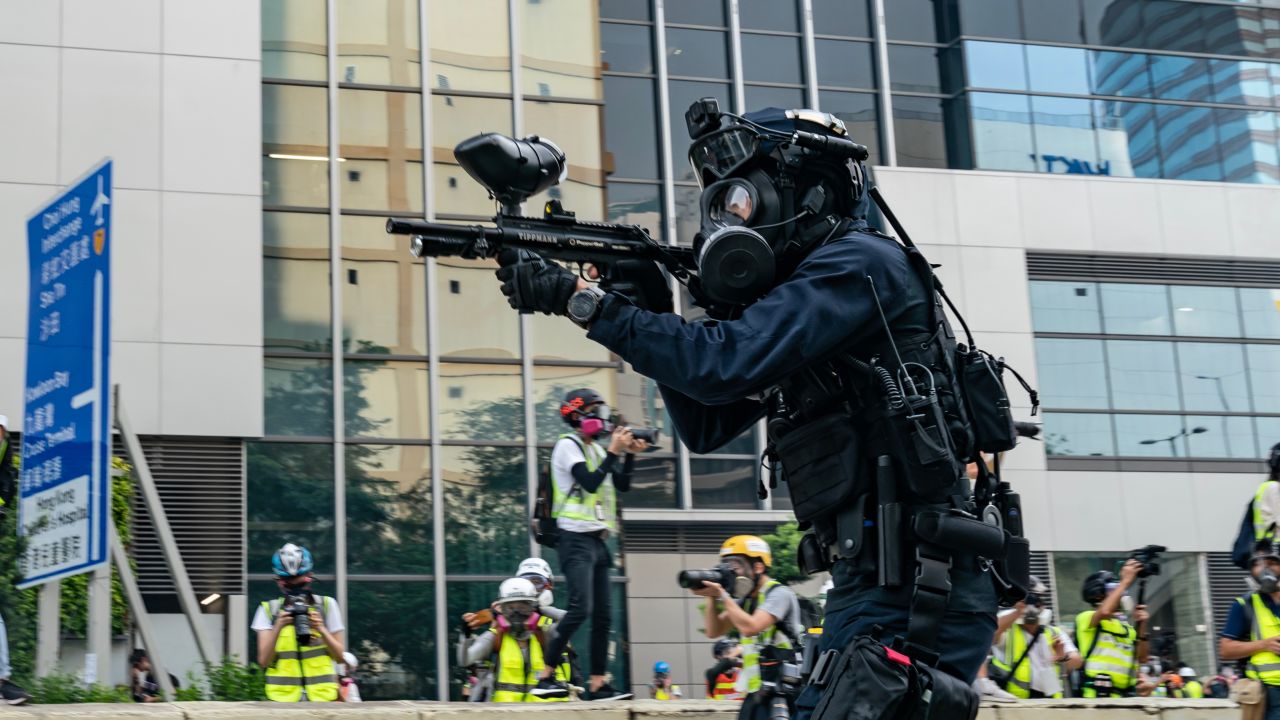 HONG KONG, CHINA - AUGUST 24: A riot police fires rubber bullet at protesters during an anti-government rally in Kowloon Bay district on August 24, 2019 in Hong Kong, China. Pro-democracy protesters have continued rallies on the streets of Hong Kong against a controversial extradition bill since 9 June as the city plunged into crisis after waves of demonstrations and several violent clashes. Hong Kong's Chief Executive Carrie Lam apologized for introducing the bill and declared it "dead", however protesters have continued to draw large crowds with demands for Lam's resignation and completely withdraw the bill. (Photo by Anthony Kwan/Getty Images)