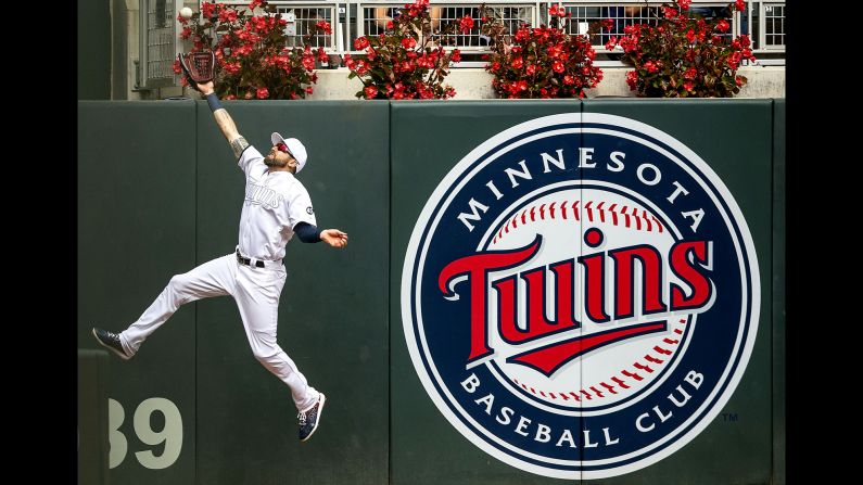 Minnesota Twins left fielder Jake Cave makes a catch at the wall during an MLB game against the Detroit Tigers in Minneapolis, on Sunday, August 25.