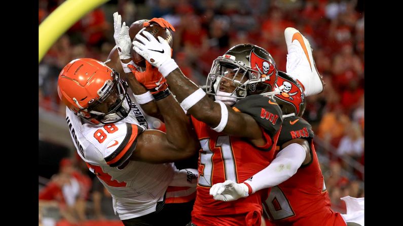 Demetrius Harris of the Cleveland Browns, left, has a pass broken up by Jordan Whitehead of the Tampa Bay Buccaneers during an NFL preseason game at Raymond James Stadium in Tampa, Florida, on Friday, August 23.