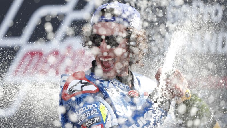 Spanish rider Alex Rins sprays champagne on the podium as he celebrates his victory in the Moto GP British Grand Prix at Silverstone circuit in Northamptonshire, England, on August 25.
