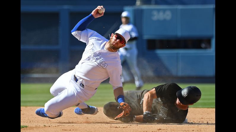 New York Yankees left fielder Brett Gardner knocks over Los Angeles Dodgers second baseman Max Muncy while attempting to break up a double play in the top of the ninth inning of a game at Dodger Stadium on August 24.
