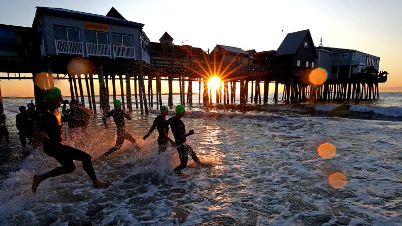 Athletes begin the swim portion of the Ironman 70.3 Maine triathlon in Old Orchard Beach, Maine, on Sunday, August 25.