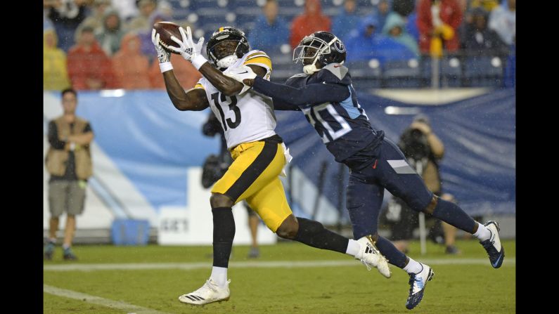 Pittsburgh Steelers wide receiver James Washington catches a 41-yard touchdown pass while defended by Tennessee Titans defensive back Kenneth Durden in the first half of a preseason NFL football game in Nashville, Tennessee, on Sunday, August 25.