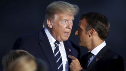 U.S President Donald Trump talks to French President Emmanuel Macron during the G7 family photo Sunday, Aug. 25, 2019 in Biarritz. A top Iranian official paid an unannounced visit Sunday to the G-7 summit and headed straight to the buildings where leaders of the world's major democracies have been debating how to handle the country's nuclear ambitions. (Christian Hartmann, Pool via AP)