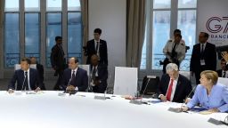 From the left, French President Emmanuel Macron, Egyptian President and Chairman of the African Union Abdel Fattah al-Sissi, Chile's President Sebastian Pinera and German Chancellor Angela Merkel attend a work session focused on climate in Biarritz, southwestern France, Monday August 26, 2019, on the third day of the annual G7 Summit. The empty seat at third right was the place reserved for President Donald Trump, who according to Macron had skipped Monday's working session on the climate. 