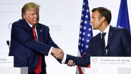 France's President Emmanuel Macron (R) and US President Donald Trump shake hands as they deliver a joint press conference in Biarritz, south-west France on August 26, 2019, on the third day of the annual G7 Summit attended by the leaders of the world's seven richest democracies, Britain, Canada, France, Germany, Italy, Japan and the United States.