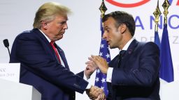France's President Emmanuel Macron (R) and  US President Donald Trump shake hands during a joint-press conference in Biarritz, south-west France on August 26, 2019, on the third day of the annual G7 Summit attended by the leaders of the world's seven richest democracies, Britain, Canada, France, Germany, Italy, Japan and the United States.