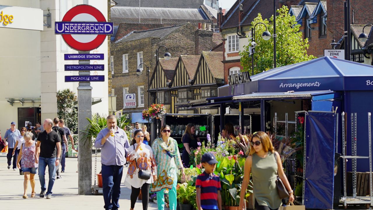 Shoppers mill around Uxbridge town center.