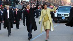 WASHINGTON - JANUARY 20:  U.S. President Barack Obama and first lady Michelle Obama wave as they walk in the inaugural parade following his inauguration as the 44th President of the United States of America on January 20, 2009 in Washington, D.C. Obama is the first African-American to be elected to the office of President in the history of the U.S.  (Photo by Doug Mills-Pool/Getty Images)