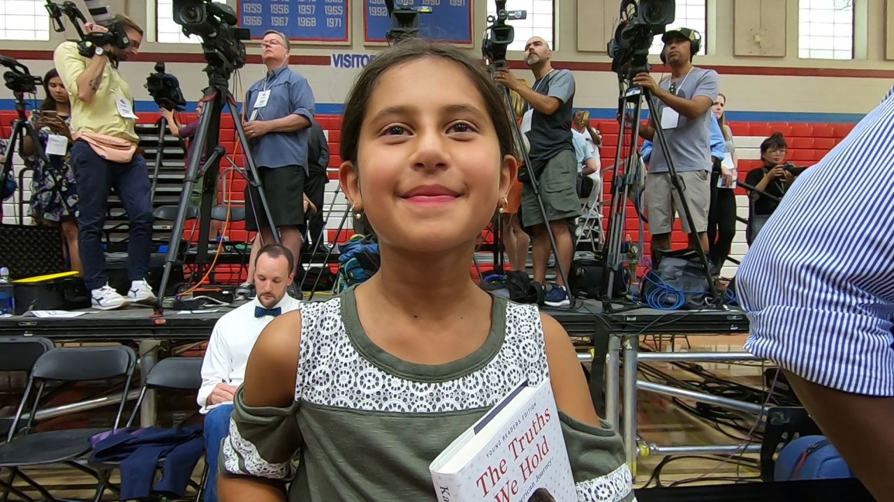 Katerina Shadrach holds a book by Kamala Harris as she waits to see the senator take the stage in 2019.