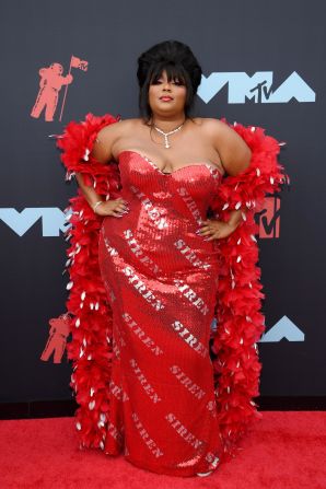 Best New Artist nominee Lizzo wowed in a figure-celebrating custom gown by Moschino, which she accessorized with a red feather boa.